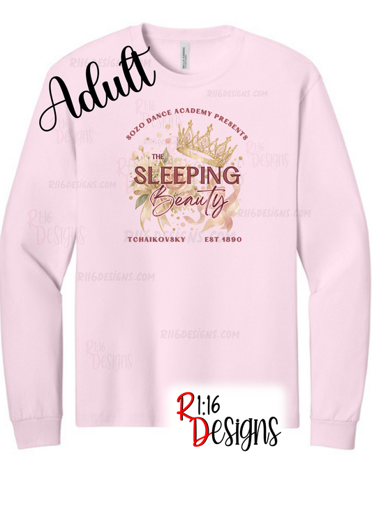 A light pink long-sleeve crewneck sweatshirt with a graphic print on the front. The graphic features a gold crown, floral elements, and the text 'The Sleeping Beauty' along with 'SoZo Dance Academy Presents' and 'Tchaikovsky Est 1890'.